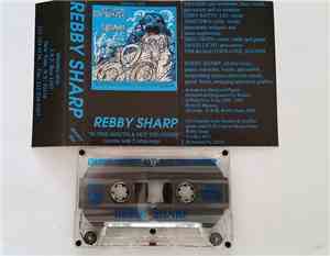 Rebby Sharp - In One Mouth And Out The Other